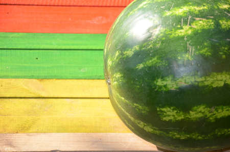 Whole watermelon on a multi colored backgroundの写真素材