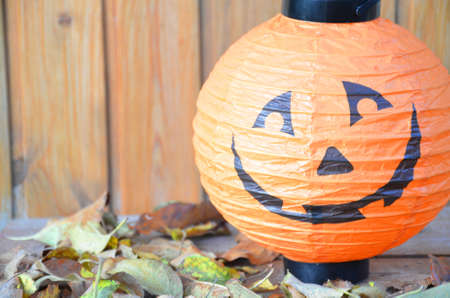 lantern in the shape of a pumpkin on a wooden halloween staircase, pumpkins and autumn decorations on old wooden.の写真素材