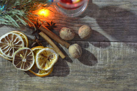christmas hot mulled wine with cinnamon cardamom and anise on wooden backgroundの写真素材