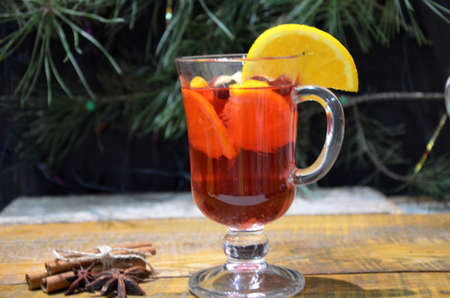 Mulled wine in glasses with spices on wooden table.の写真素材