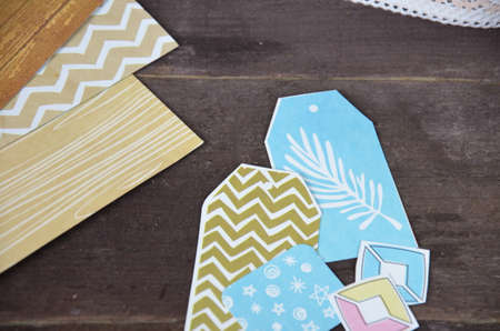 Top view of table with elements for scrapbooking, tools for decoration and handmade albums and...