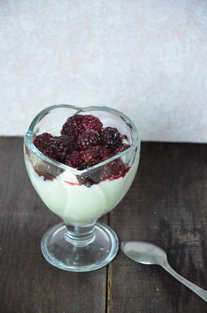 Various dessert breakfast pudding, rice porridge in glass decorated by fresh blackberries, pudding, ice cream, yogurt with blackberries. Beautiful, delicious, low-calorie dessert Breakfast, snack.の写真素材
