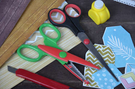 Top view of table with elements for scrapbooking, tools for decoration and handmade albums and cards. Craft materials. hobbyの写真素材