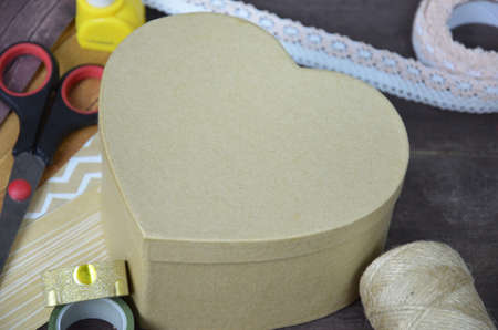 Top view of table with elements for scrapbooking, tools for decoration and handmade albums and cards. Craft materials. hobby. a gift for St. Valentine's Day. heart shapeの写真素材