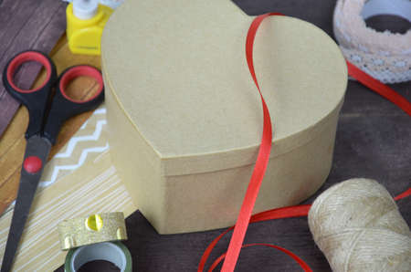 Top view of table with elements for scrapbooking, tools for decoration and handmade albums and cards. Craft materials. hobby. a gift for St. Valentine's Day. heart shapeの写真素材