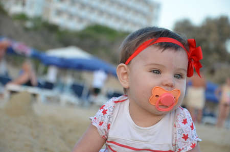 cute little girl play with seashells on beachの写真素材
