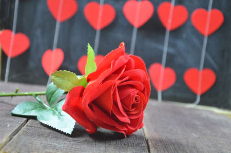Red roses with hearts on a old wooden table, valentines dayの写真素材