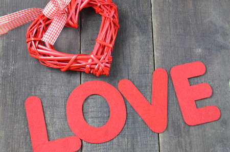 beautiful red heart ornaments on a wooden background on Valentine's Day, word love letters, inscription on Valentine's Day, feast of love in Februaryの写真素材
