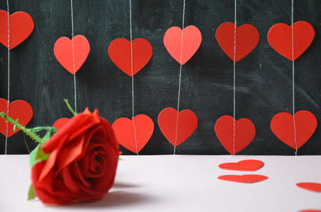 Gift or present box with red bow ribbon and heart on wooden table for Valentines dayの写真素材
