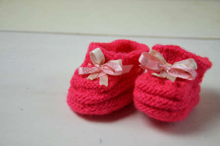 Baby girl knitted sandal, booties, shoes baby newborn, blank postcard. cocept it s a girl or baby showerの写真素材