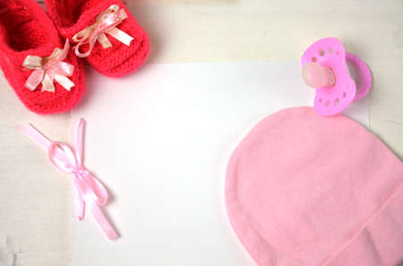 Baby girl knitted sandal, booties, shoes baby newborn, blank postcard. cocept it s a girl or baby showerの写真素材