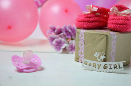 A newborn baby girl background. Newborn accessories for a baby girl on a pink wooden background.の写真素材
