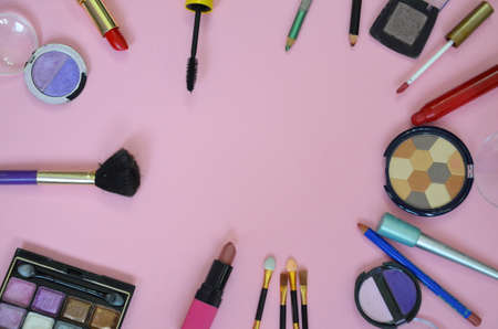 Make up bag, brush with cosmetics on pink backgroundの写真素材