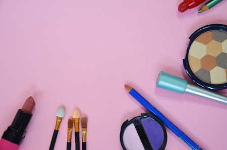 Make up bag, brush with cosmetics on pink backgroundの写真素材