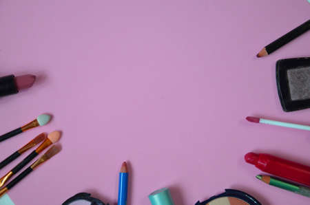 Make up bag, brush with cosmetics on pink backgroundの写真素材
