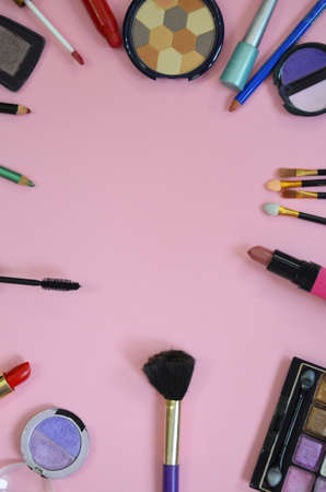 Make up bag, brush with cosmetics on pink backgroundの写真素材
