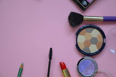 Make up bag, brush with cosmetics on pink backgroundの写真素材