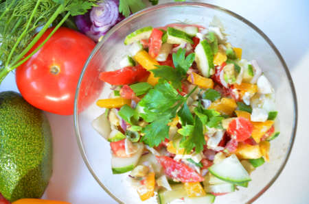 Vegetable Salad with avocado, tomato, sweet peper and greens on the white backgroundの写真素材