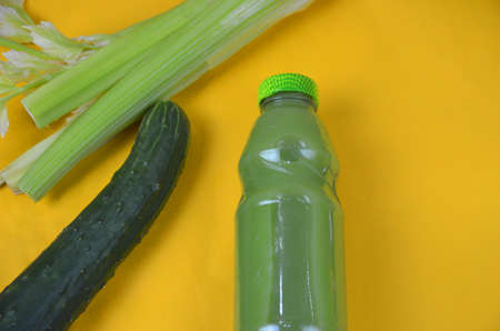 Fresh Green Juice with cucumber, celery on yellow backgroundの写真素材