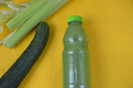 Fresh Green Juice with cucumber, celery on yellow backgroundの写真素材