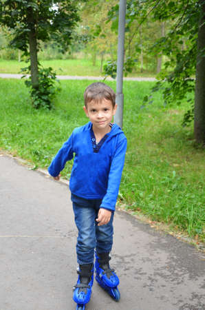 Cute little child, boy, skating in the park, springtimeの写真素材