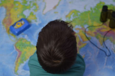 children with maps and travel backpacks on steppe valleys in summerの写真素材