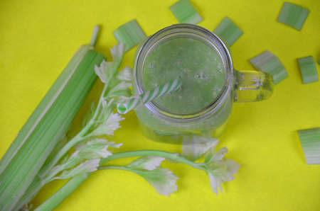 Green smoothie in glass over rustic wooden background with copy space - detox, vegan, vegetarian healthy vegetable drinkの写真素材