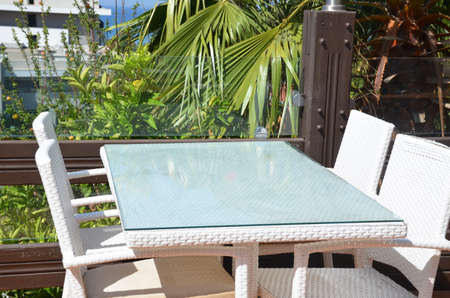 empty table in a summer street cafe overlooking the sea, palm trees. The concept of rest, vacation, summerの写真素材