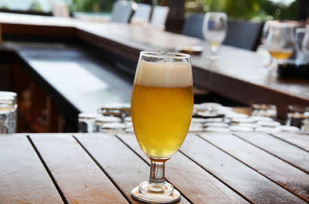 Close up of a glass of beer in a barの写真素材