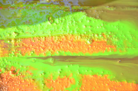 bright yellow wood surface as background. Abstract hand drawn watercolor. Colorful splashing on the woodの写真素材