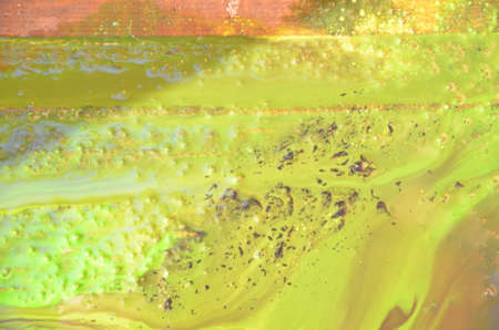 bright yellow wood surface as background. Abstract hand drawn watercolor. Colorful splashing on the woodの写真素材