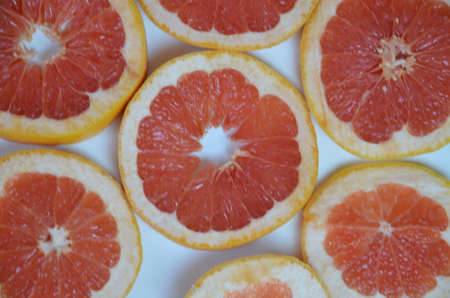 Beautiful fresh sliced mixed citrus fruits like background, concept of healthy eating, dieting, top viewの写真素材