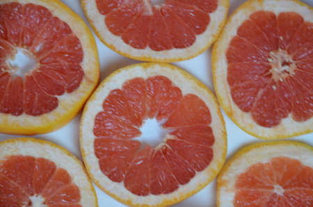 Beautiful fresh sliced mixed citrus fruits like background, concept of healthy eating, dieting, top viewの写真素材