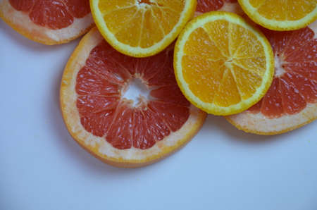 Beautiful fresh sliced mixed citrus fruits like background, concept of healthy eating, dieting, top viewの写真素材