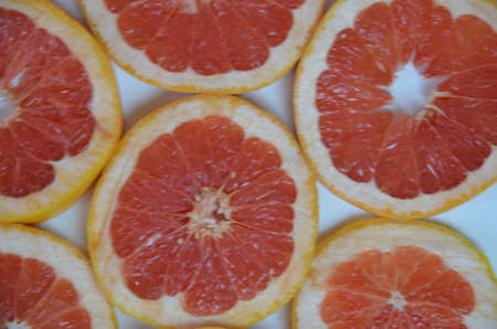 Beautiful fresh sliced mixed citrus fruits like background, concept of healthy eating, dieting, top viewの写真素材