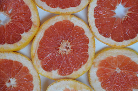 Beautiful fresh sliced mixed citrus fruits like background, concept of healthy eating, dieting, top viewの写真素材