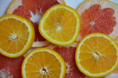 Beautiful fresh sliced mixed citrus fruits like background, concept of healthy eating, dieting, top viewの写真素材