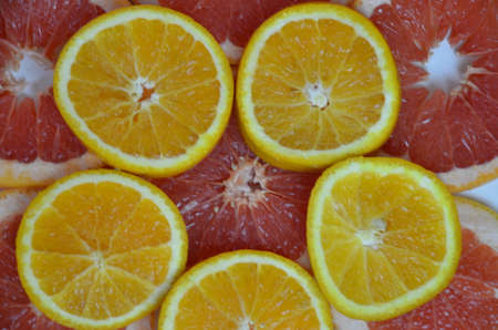 Beautiful fresh sliced mixed citrus fruits like background, concept of healthy eating, dieting, top viewの写真素材