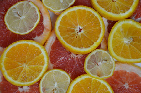 Beautiful fresh sliced mixed citrus fruits like background, concept of healthy eating, dieting, top viewの写真素材