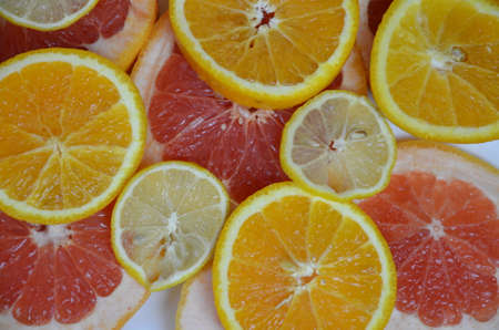 Beautiful fresh sliced mixed citrus fruits like background, concept of healthy eating, dieting, top viewの写真素材