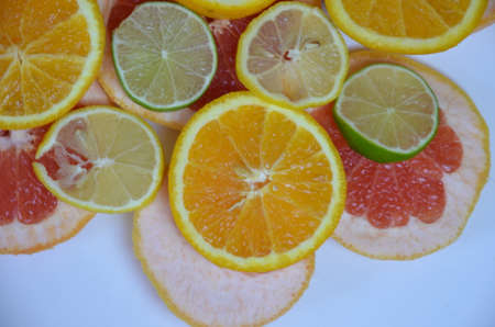 Beautiful fresh sliced mixed citrus fruits like background, concept of healthy eating, dieting, top viewの写真素材