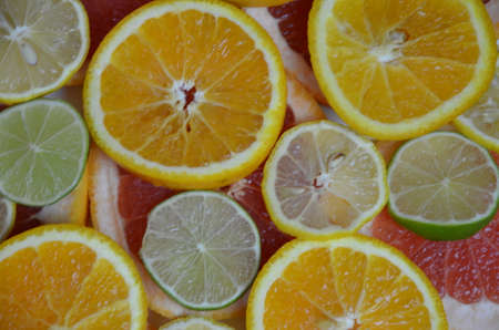 Beautiful fresh sliced mixed citrus fruits like background, concept of healthy eating, dieting, top viewの写真素材