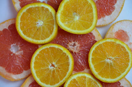 beautiful fresh sliced mixed citrus fruits like background, concept of healthy eating, dieting, top viewの写真素材