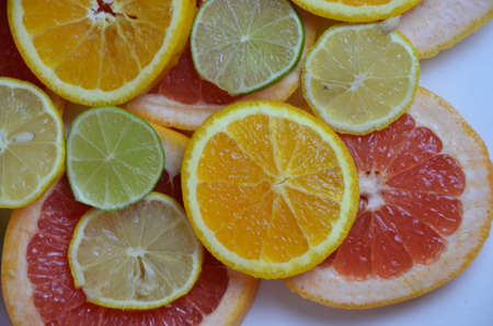 beautiful fresh sliced mixed citrus fruits like background, concept of healthy eating, dieting, top viewの写真素材