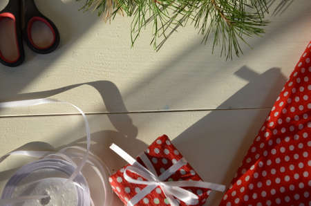 Christmas gift wrapping background, copy space. present box wrapped in kraft, top view. Winter...