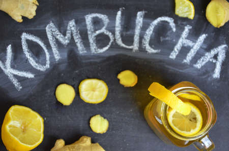 Homemade fermented raw kombucha tea with different flavorings. Healthy natural probiotic flavored drink with lemon and ginger or ginger ale. Copy space.の写真素材