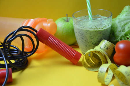 Diet and Healthy life Concept. Green apple and Weight scale,measure tap with fresh vegetable, clean water and sport equipment for women diet slimming. green smoothieの写真素材
