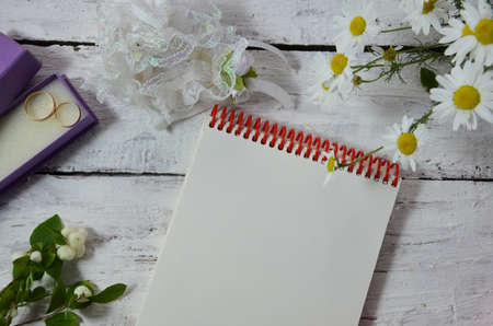 Wedding to do list top view. Present boxes, calendar for marriage planning and various bridal stuff on white rustic table. Memmorable date organization background.の写真素材