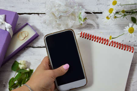 Wedding to do list top view. Present boxes, calendar for marriage planning and various bridal stuff on white rustic table. Memmorable date organization background.の写真素材