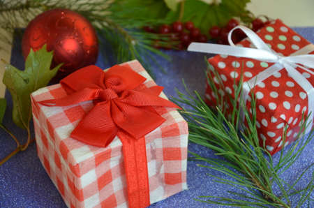 Christmas composition. Christmas gift, pine cones, fir branches on on a shimmering blue background, boke background. Flat lay, top view, copy spaceの写真素材